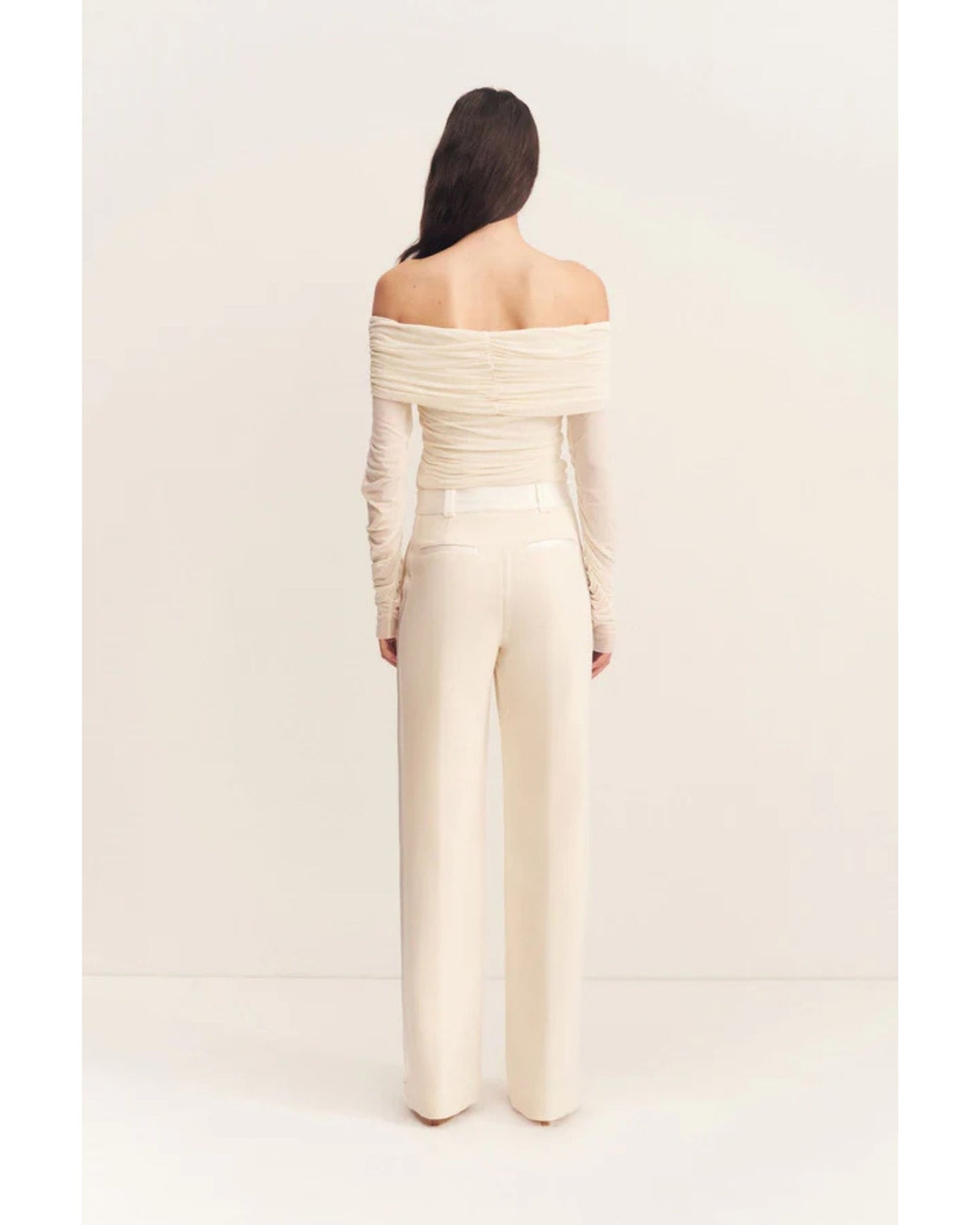 Back view, Adri Tuxedo Side Panel Pants with a contrast satin waistband, side panels, and pockets. Features include a mid-rise fit, knife pleats, jet pockets, and a relaxed straight leg. Available at Georgette bridal boutique in Brussels and online at georgettebridal.com.
