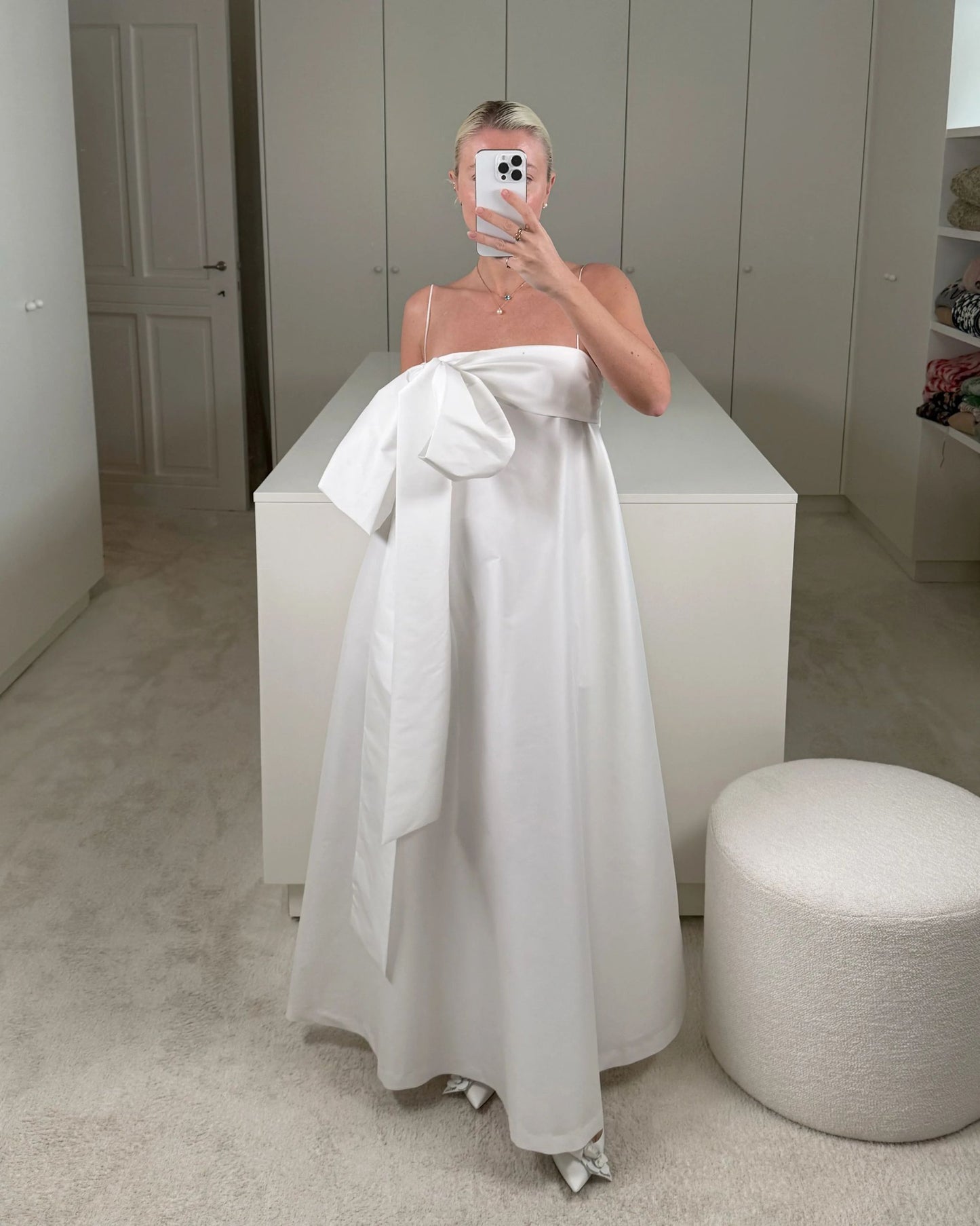 Charlotte wearing the Bailey Wedding Dress, featuring a voluminous ankle-length taffeta skirt, a structured bustier top, and a dramatic side bow detail. Available at Georgette bridal boutique in Brussels and online at georgettebridal.com.