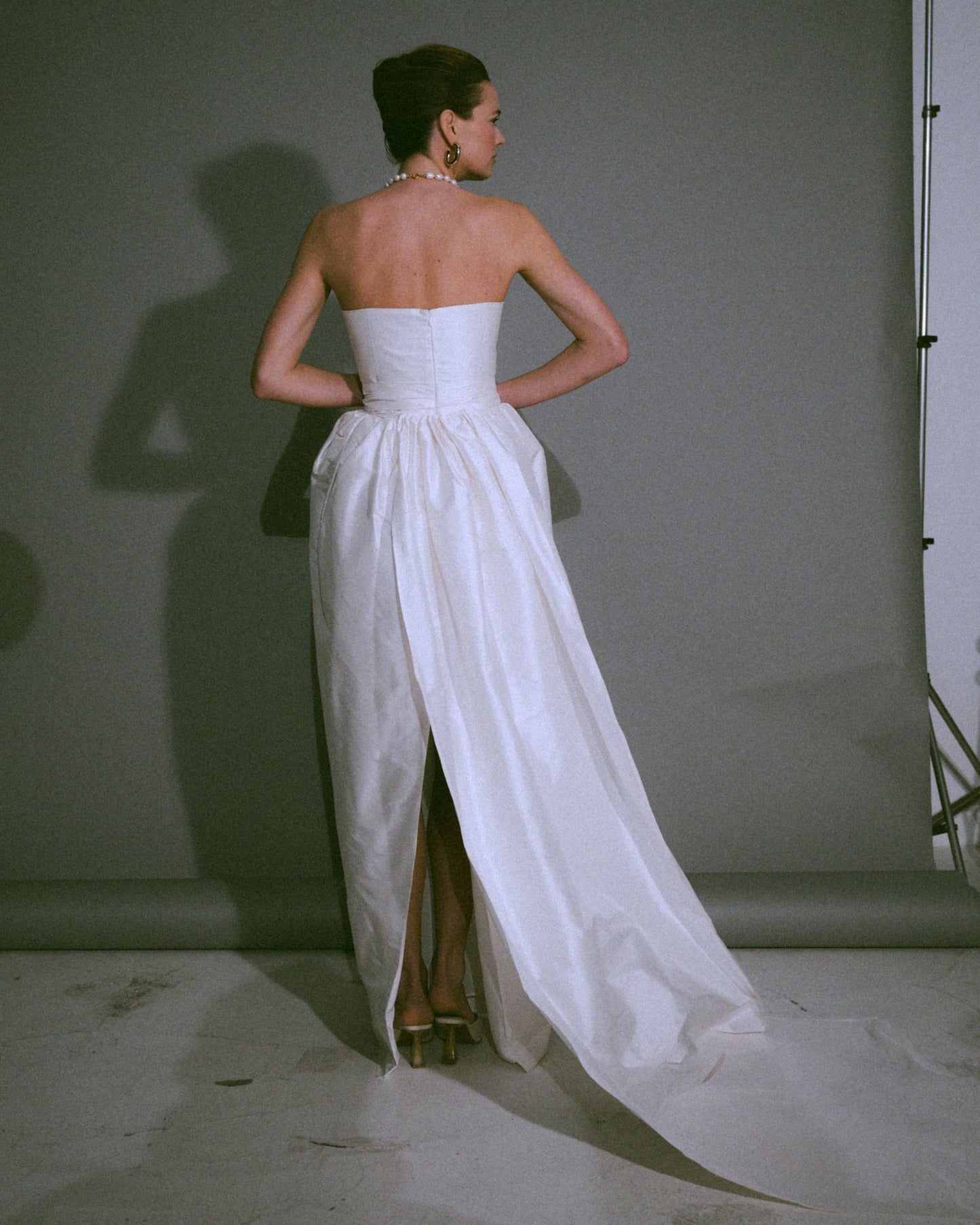 Back view of the Cece bustier wedding gown with a tulip-shaped silk skirt, handmade, available at Georgette bridal boutique in Brussels and online at georgettebridal.com.
