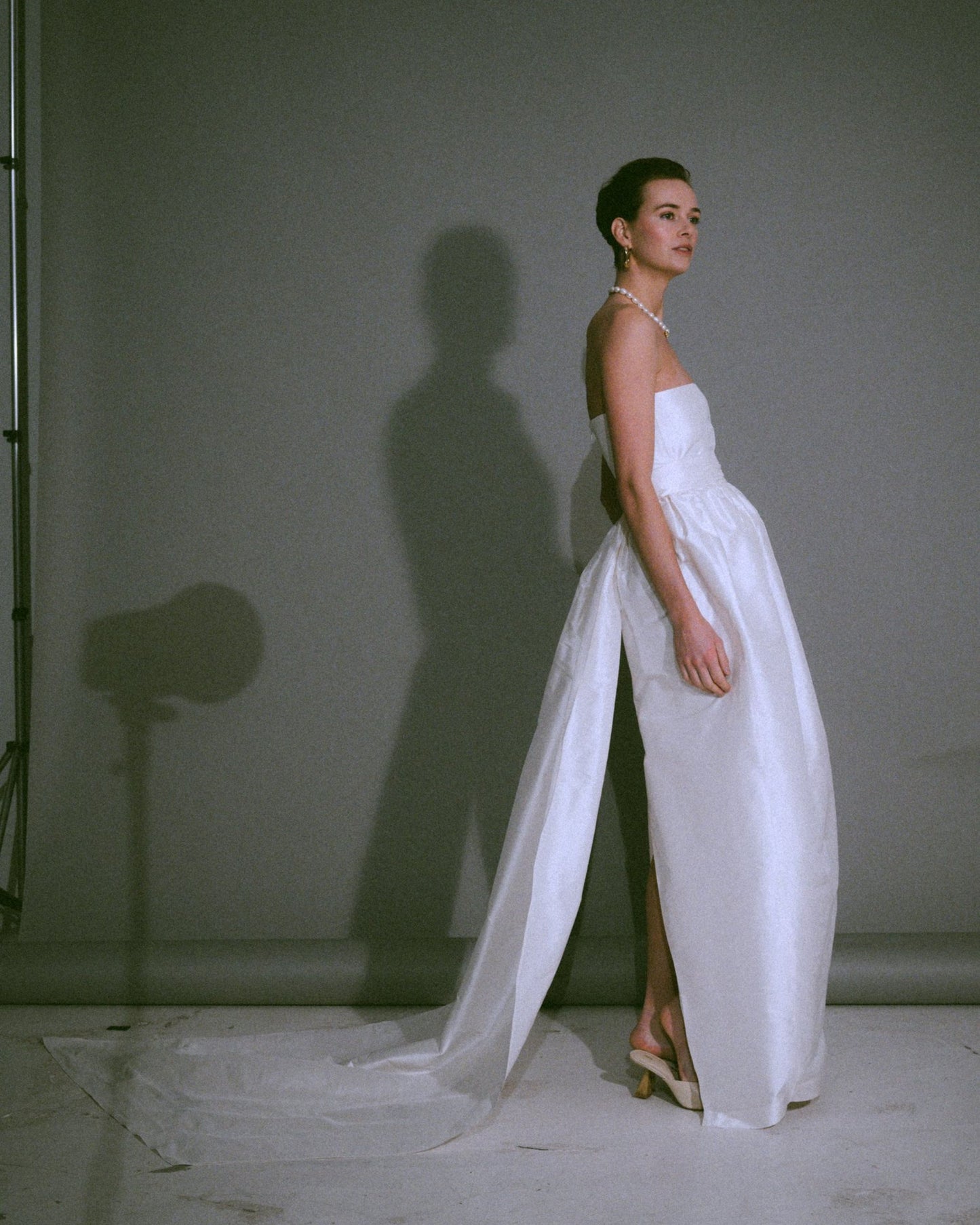 Side view of the Cece bustier wedding gown with a tulip-shaped silk skirt, handmade, available at Georgette bridal boutique in Brussels and online at georgettebridal.com.