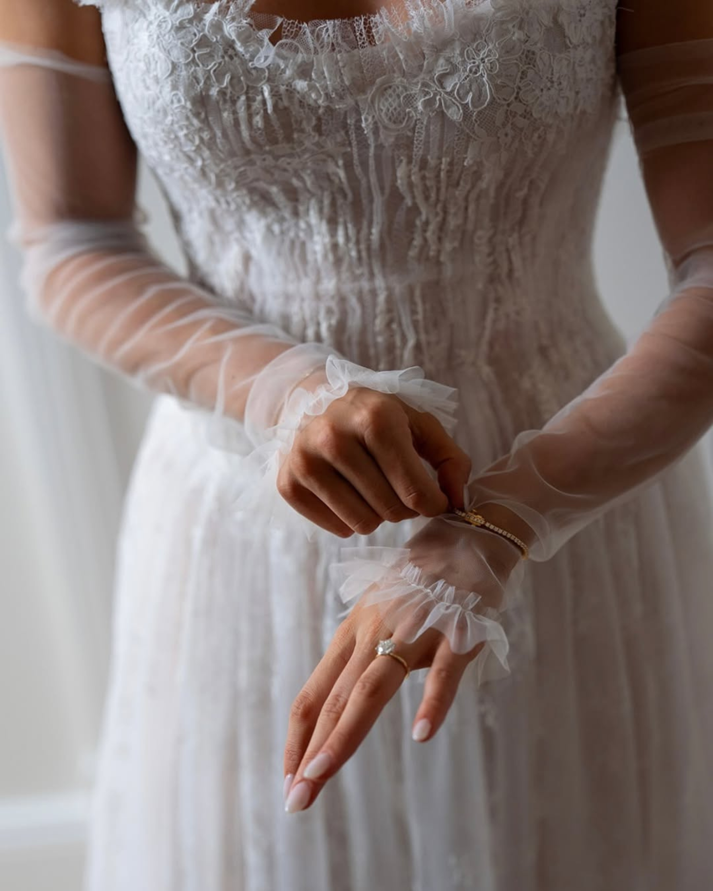 Close-up of luxury semi-sheer pleated lace wedding dress by Floure available at Georgette bridal Brussels