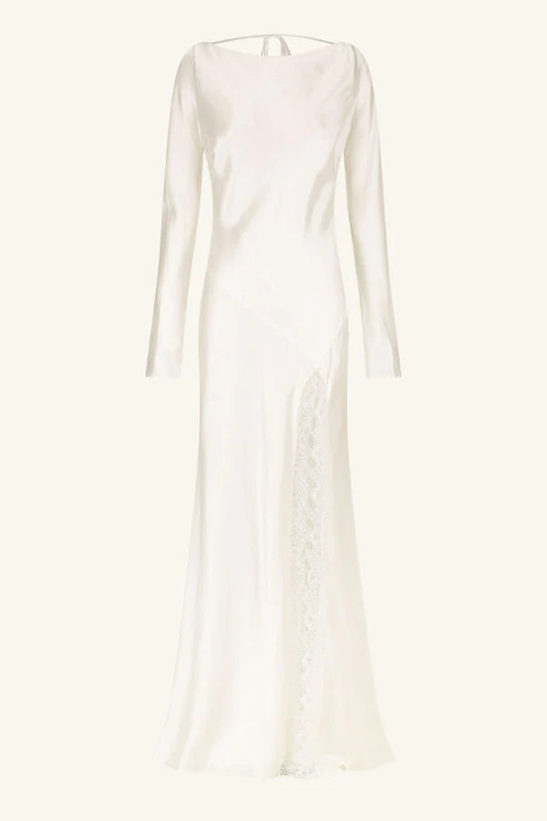 Product shot, elegant silk satin maxi wedding dress with a boat neckline, long sleeves, tapered lace details, a low cowl back, and a subtle side split. Designed for timeless, understated luxury. Available at Georgette bridal boutique in Brussels and online at georgettebridal.com.