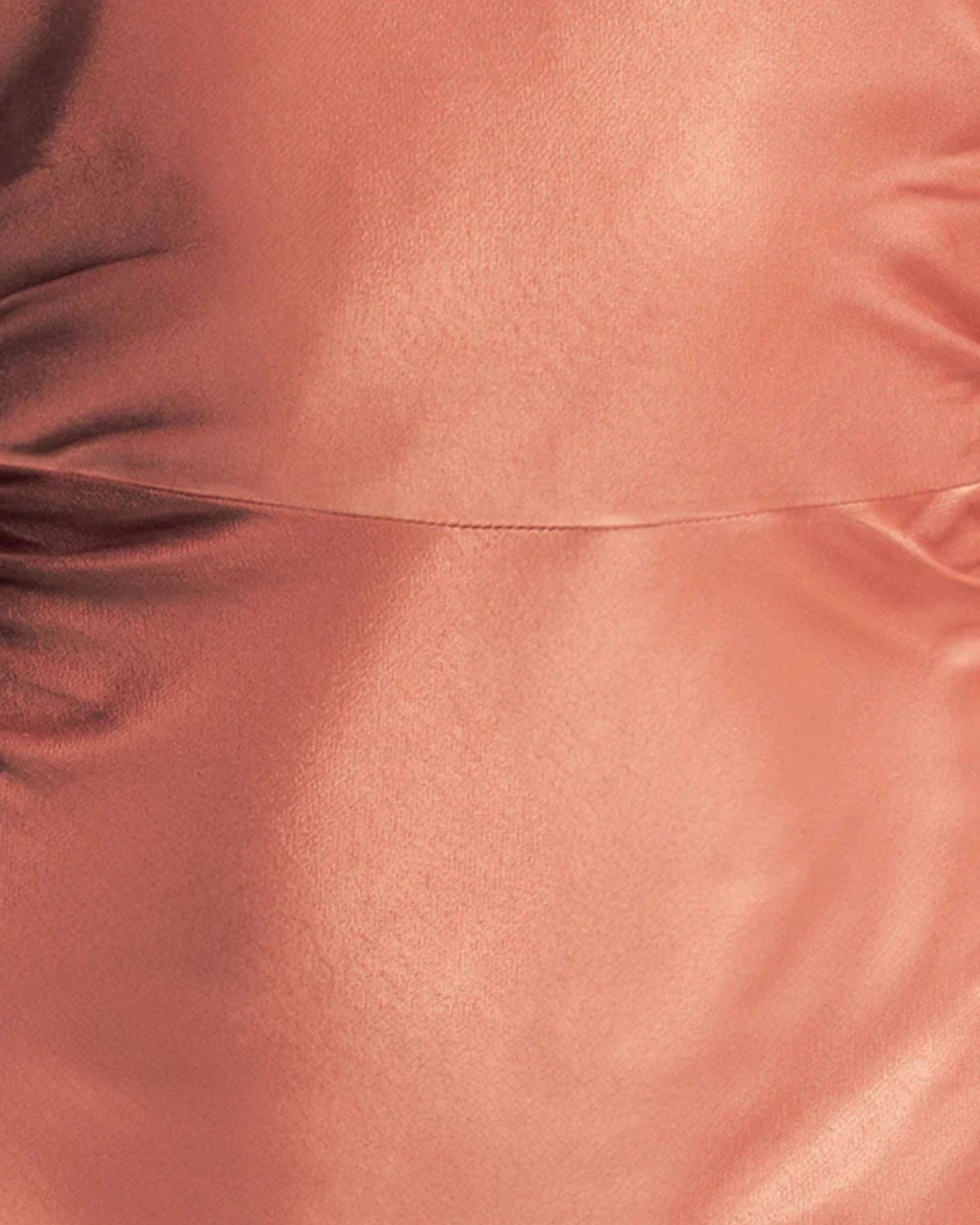 Fabric focus of an antique rose satin maxi dress with a square high neckline, halter tie, ruched waist, and low open back. Made from sustainable LENZING™ ECOVERO™ viscose. Available at Georgette bridal boutique in Brussels and online at georgettebridal.com.