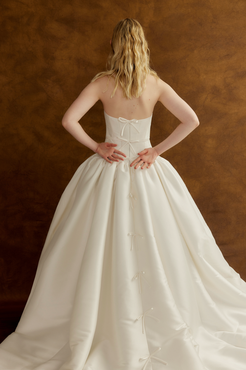 Back view of Lyn corseted wedding dress with bow detail train by Floure available at Georgette bridal Brussels