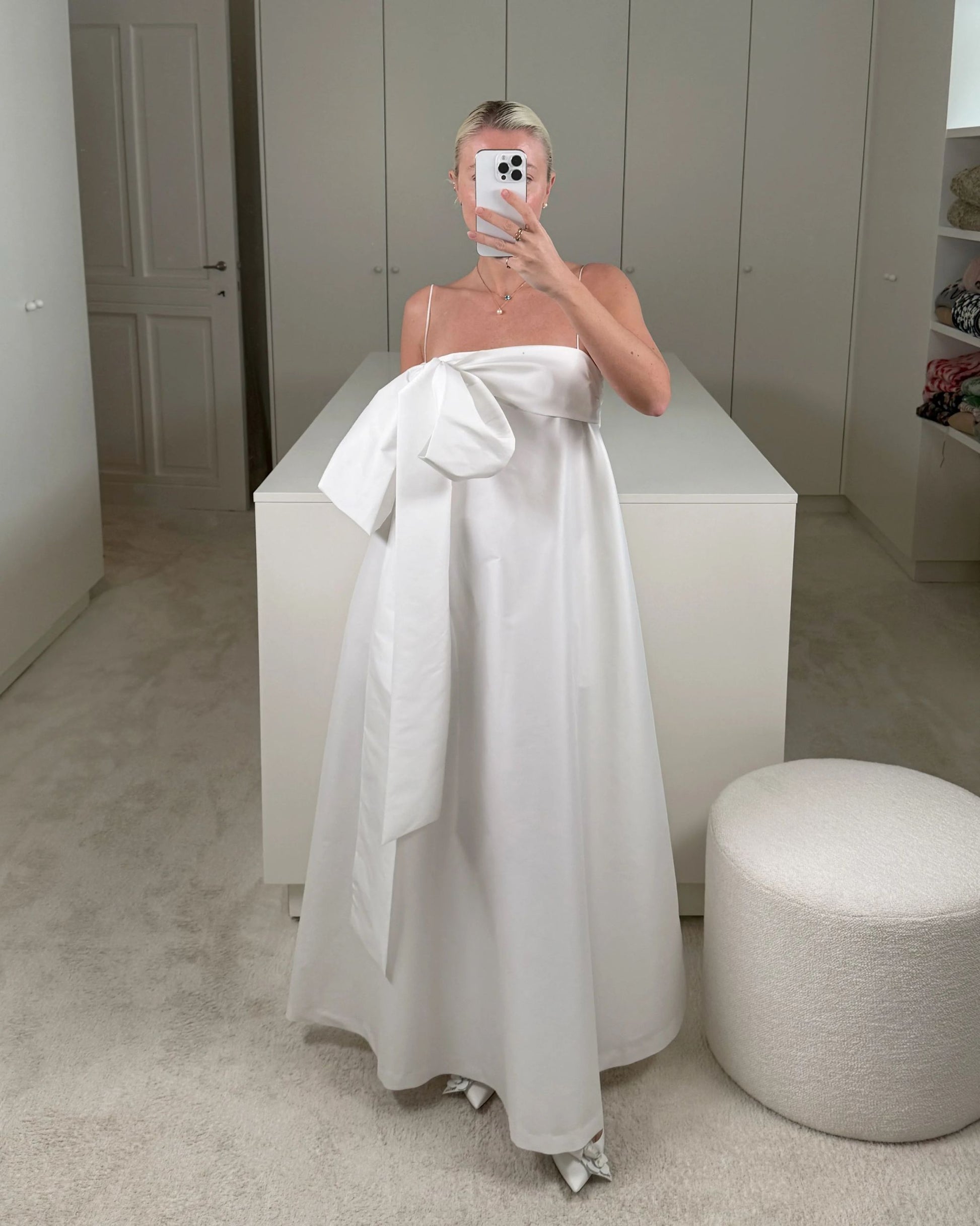 Charlotte wearing the Bailey Wedding Dress, featuring a voluminous ankle-length taffeta skirt, a structured bustier top, and a dramatic side bow detail. Available at Georgette bridal boutique in Brussels and online at georgettebridal.com.