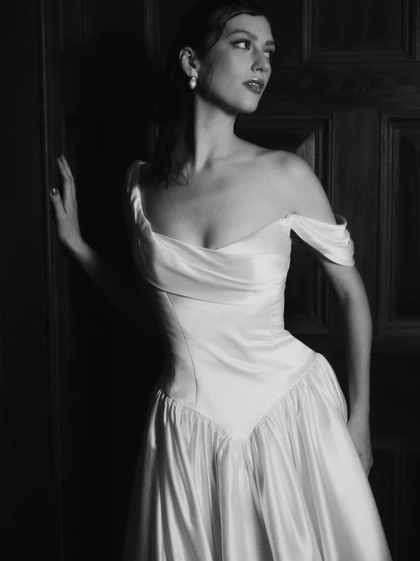 Bride in Charlotte asymmetrical neckline wedding dress by Floure available at Georgette bridal Brussels