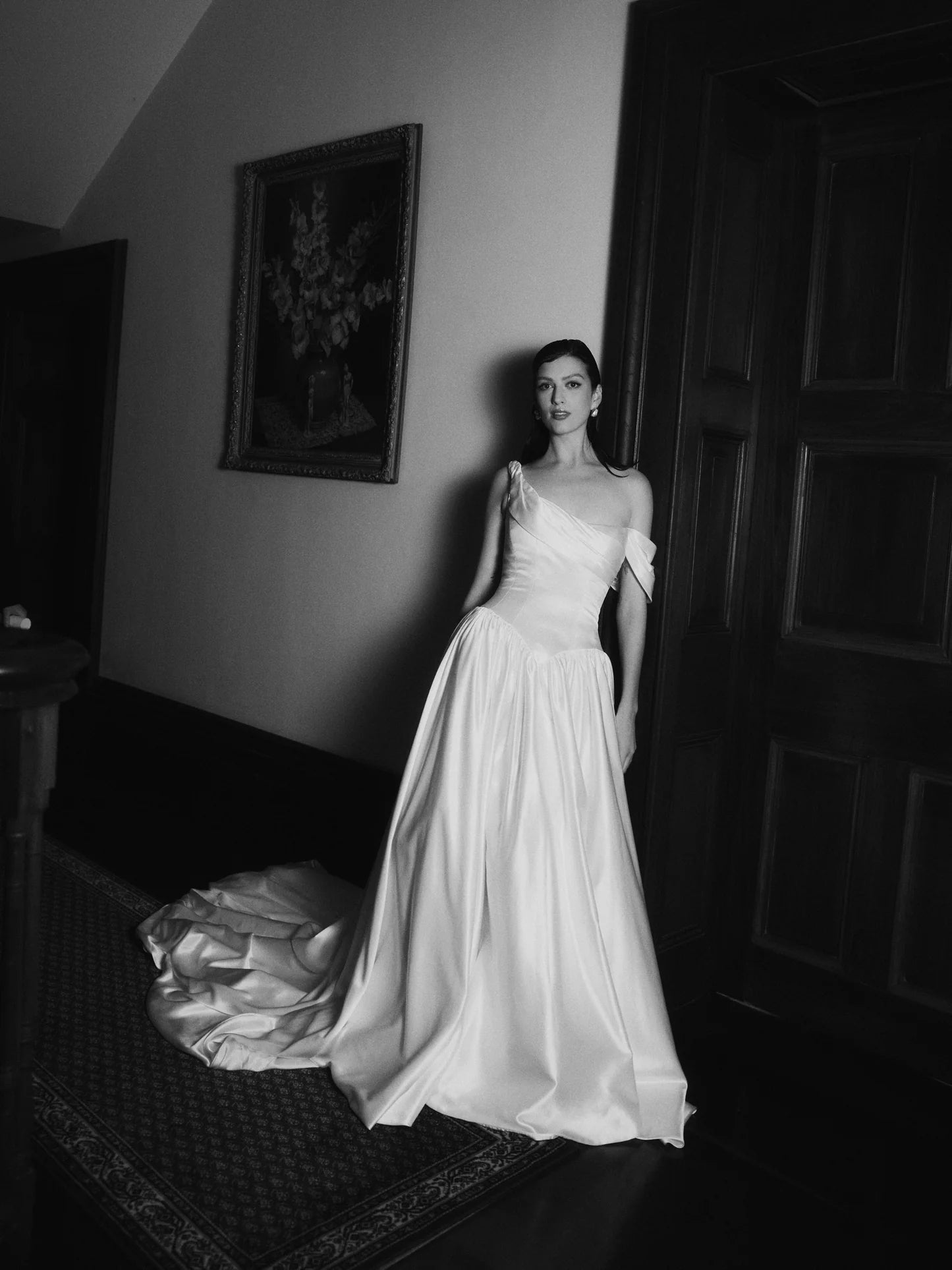 Bride in Charlotte asymmetrical neckline wedding dress with train by Floure available at Georgette bridal Brussels