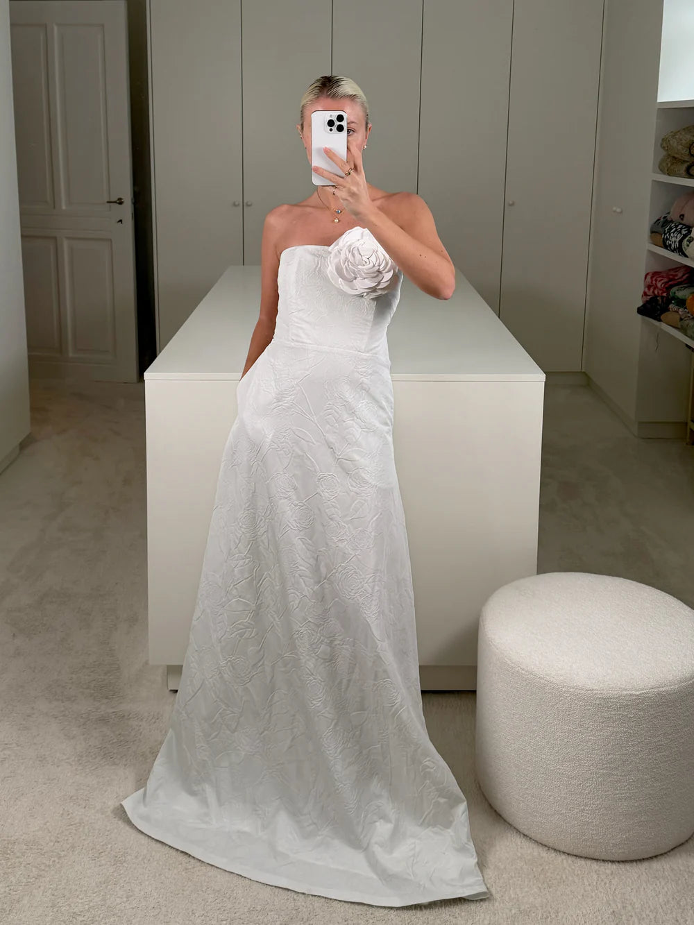 Charlotte wearing the Caswell Bustier Wedding Dress, crafted from crisp Camellia-embossed taffeta and adorned with a hand-embroidered rose appliqué at the bodice. A romantic, floor-length gown perfect for a standout bridal look. Available at Georgette bridal boutique in Brussels and online at georgettebridal.com.