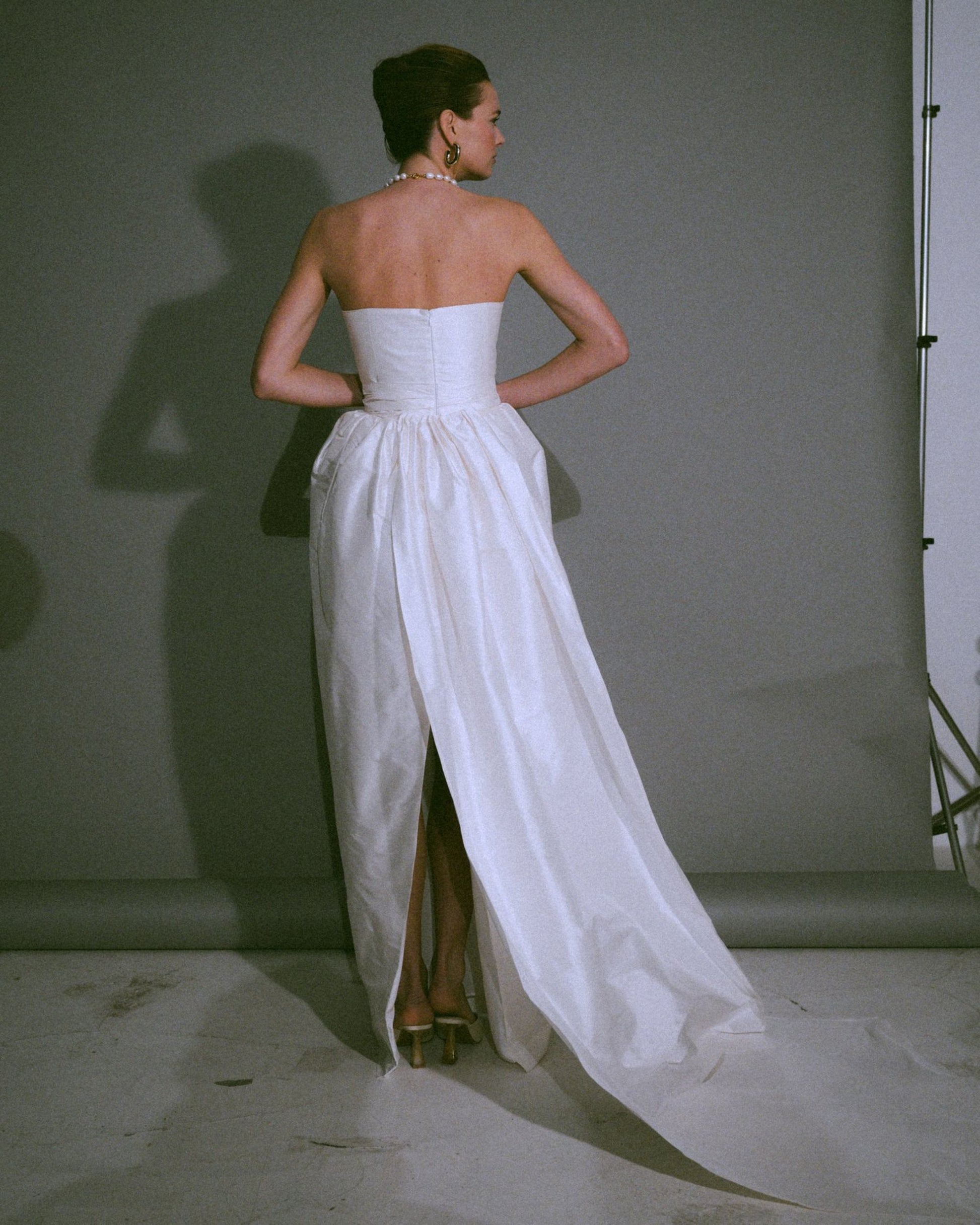 Back view of the Cece bustier wedding gown with a tulip-shaped silk skirt, handmade, available at Georgette bridal boutique in Brussels and online at georgettebridal.com.