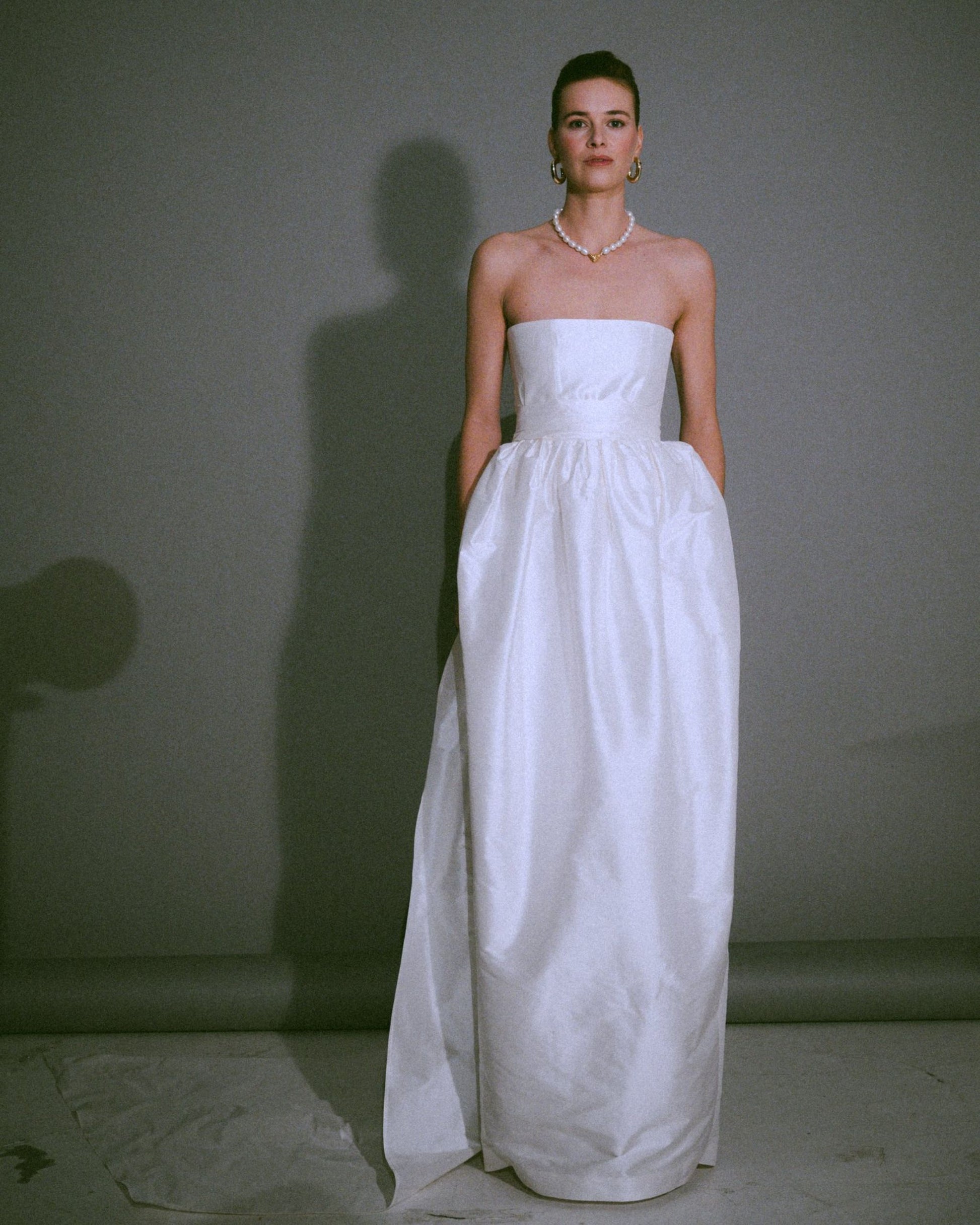 Front view of the Cece bustier wedding gown with a tulip-shaped silk skirt, handmade, available at Georgette bridal boutique in Brussels and online at georgettebridal.com.