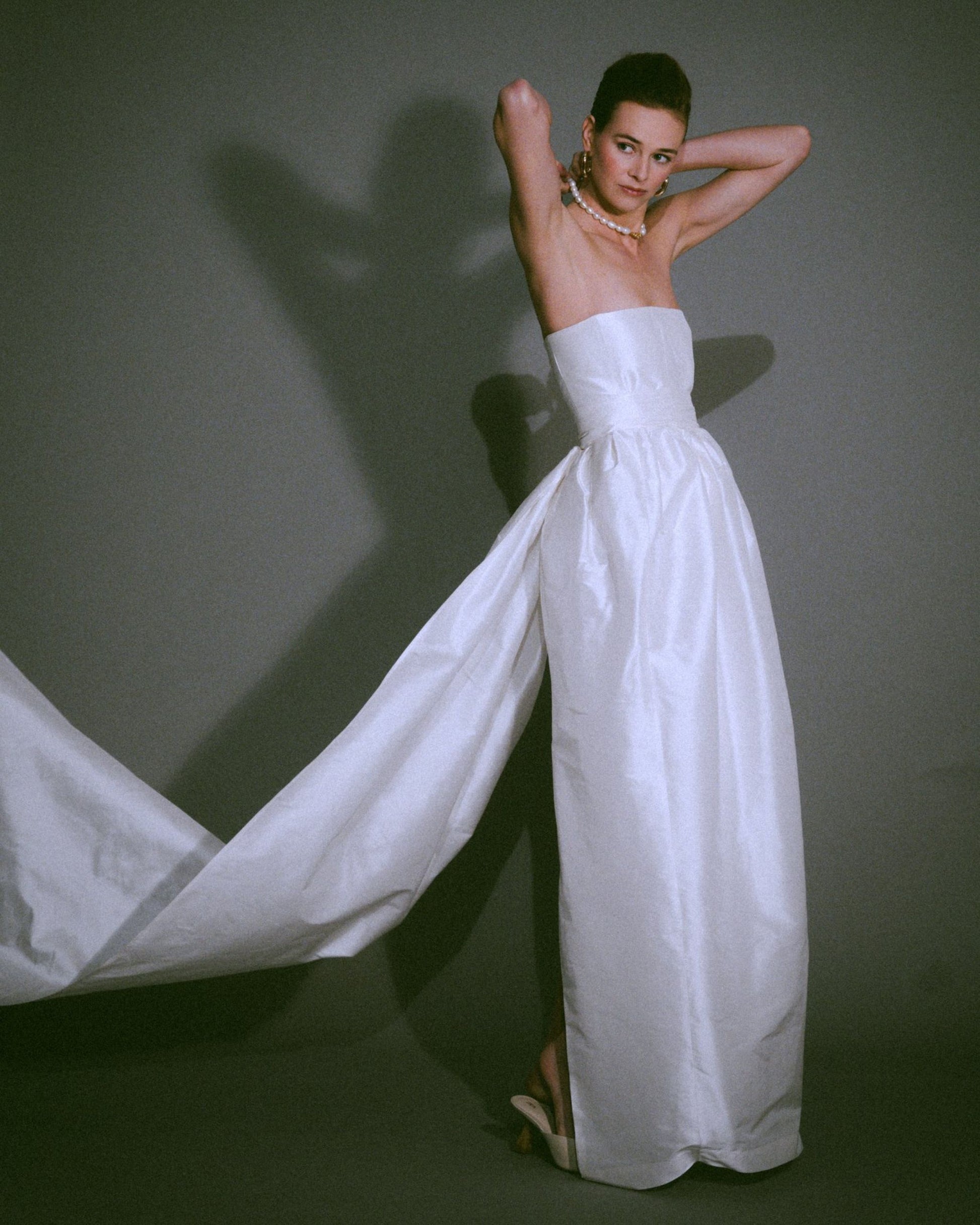 Side view view of the Cece bustier wedding gown with a tulip-shaped silk skirt, handmade, available at Georgette bridal boutique in Brussels and online at georgettebridal.com.