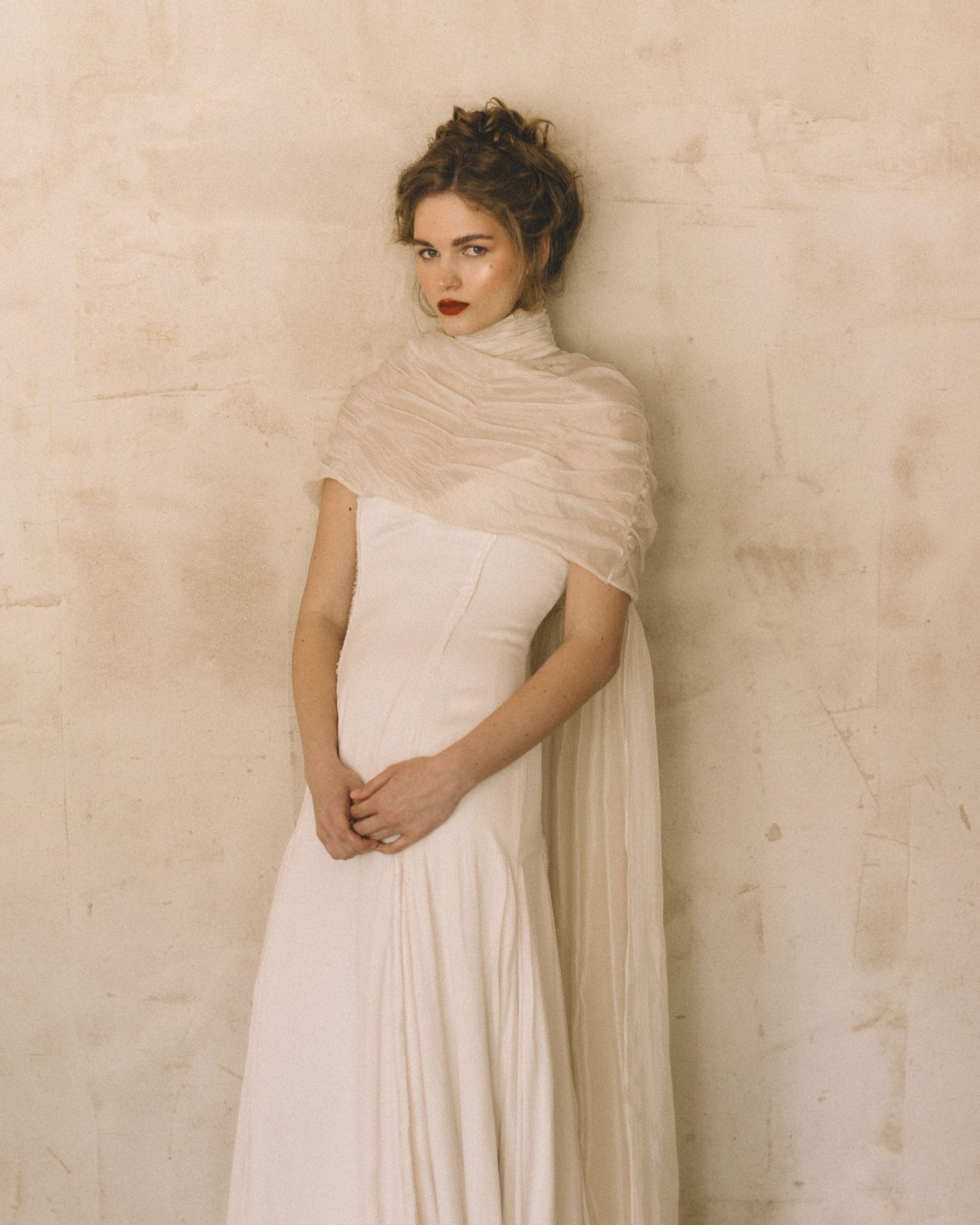 Bride wearing the Elise Cape 100% Silk Tule by The Muse Collective handmade in Spain available at Georgette in Brussels and online