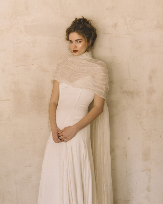 Bride wearing the Elise Cape 100% Silk Tule by The Muse Collective handmade in Spain available at Georgette in Brussels and online