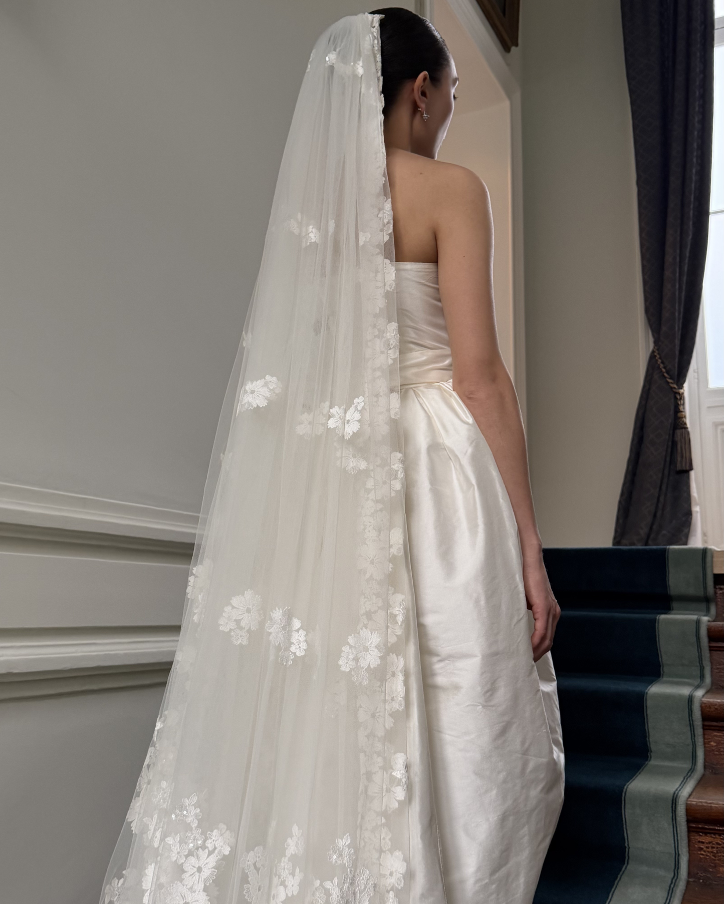 Ivory cathedral veil with floral appliqué and long train, available at Georgette bridal boutique in Brussels and online at georgettebridal.com