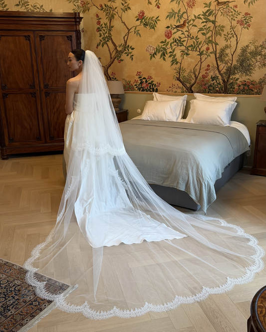 Ivory cathedral veil with lace border and long train, available at Georgette bridal boutique in Brussels and online at georgettebridal.com