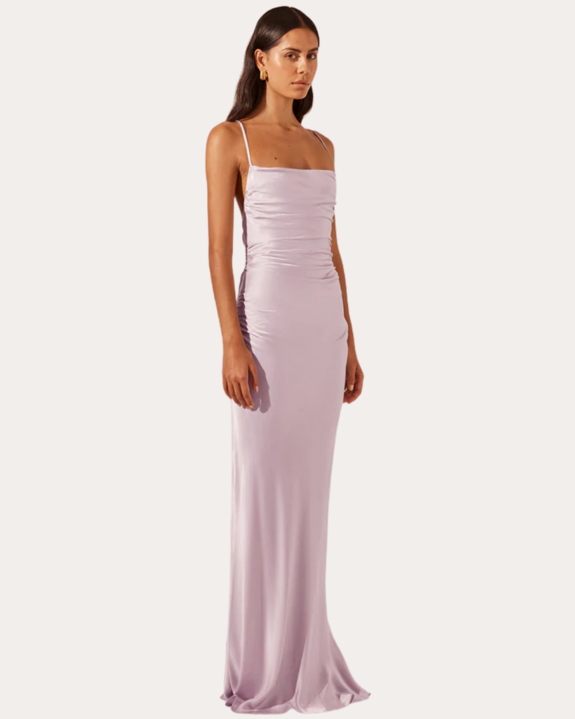Side view of the La Lune Cross Back Maxi Dress in lilac, showing ruching details and slim fit through the hips.