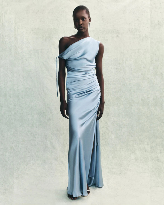 Editorial image of the La Lune One-Shoulder Dress in powder blue styled for a wedding celebration, available at Georgette Bridal in Brussels.