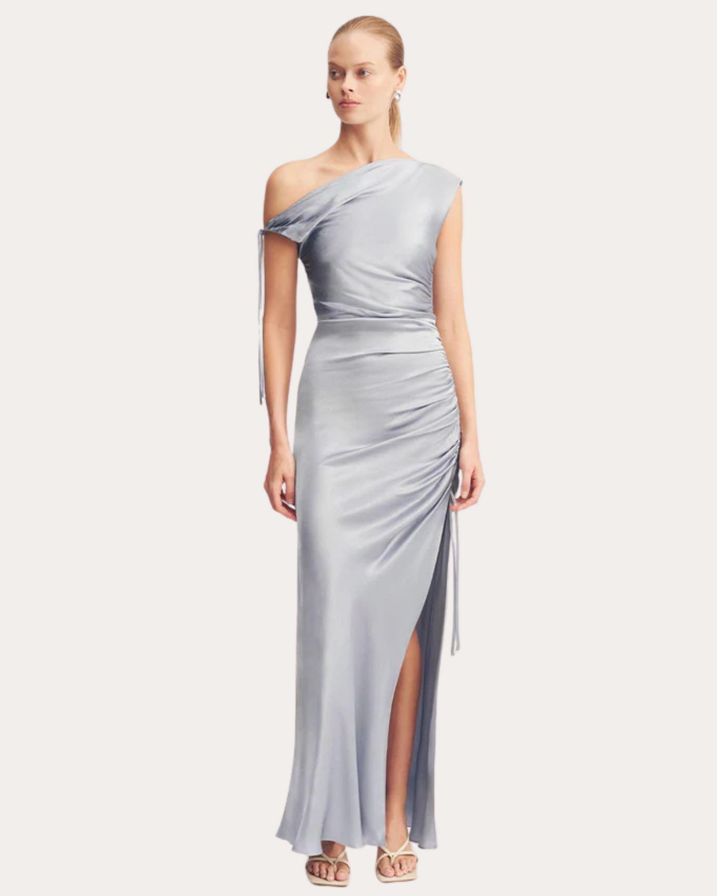 Model wearing the La Lune One-Shoulder Gathered Maxi Dress in powder blue with asymmetrical neckline, available at Georgette Bridal in Brussels.