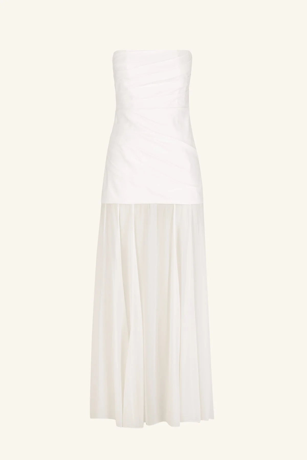 Product shot of a spliced maxi dress with a strapless white stretch cotton blend bodice featuring draped waist tucks, paired with a lightweight, semi-sheer ivory georgette skirt. Available at Georgette bridal boutique in Brussels and online at georgettebridal.com.