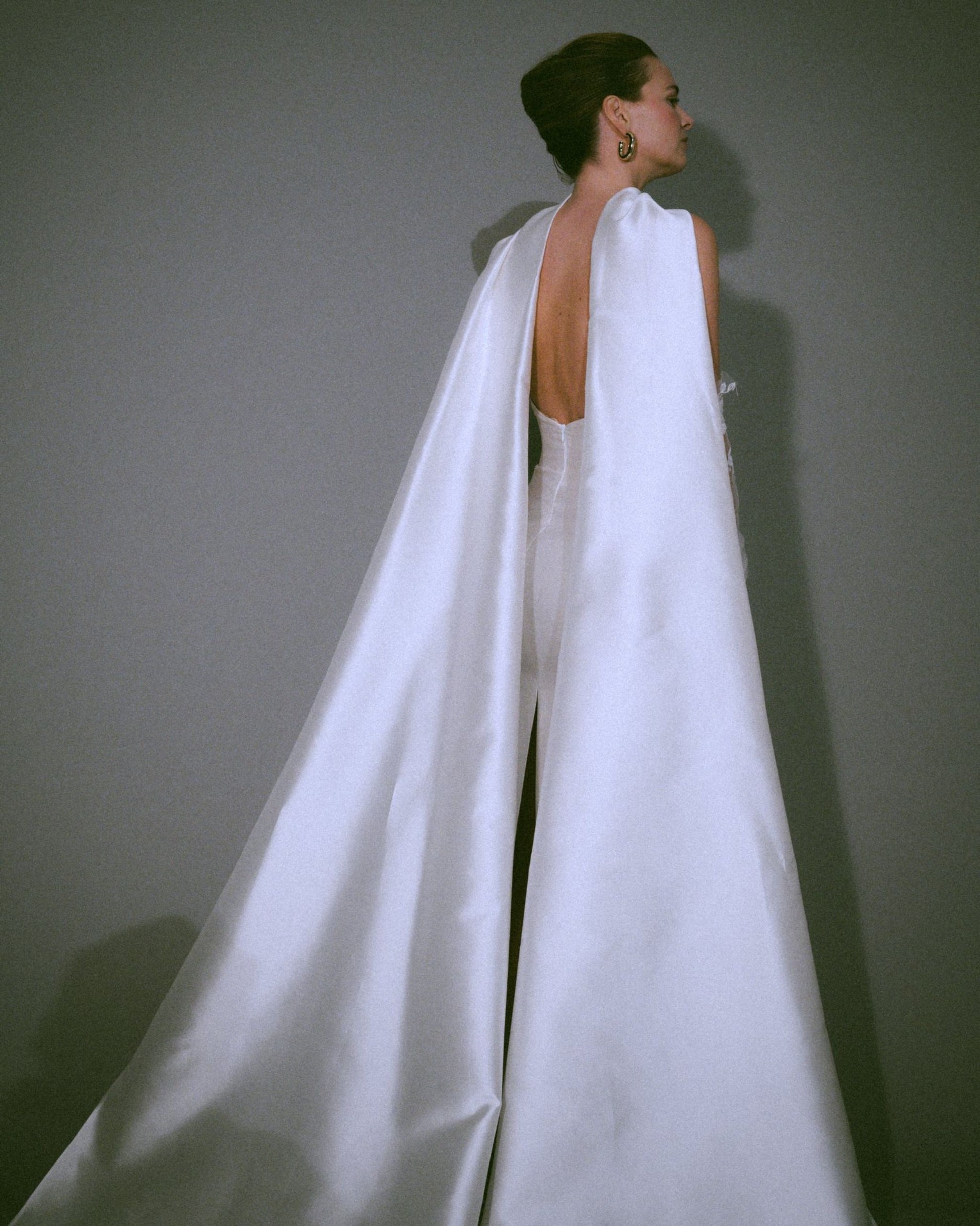 Back view of the Pia wedding gown, a handmade silk bustier wedding dress with a dramatic scarf cascading to the floor, available at Georgette bridal boutique in Brussels and online at georgettebridal.com.