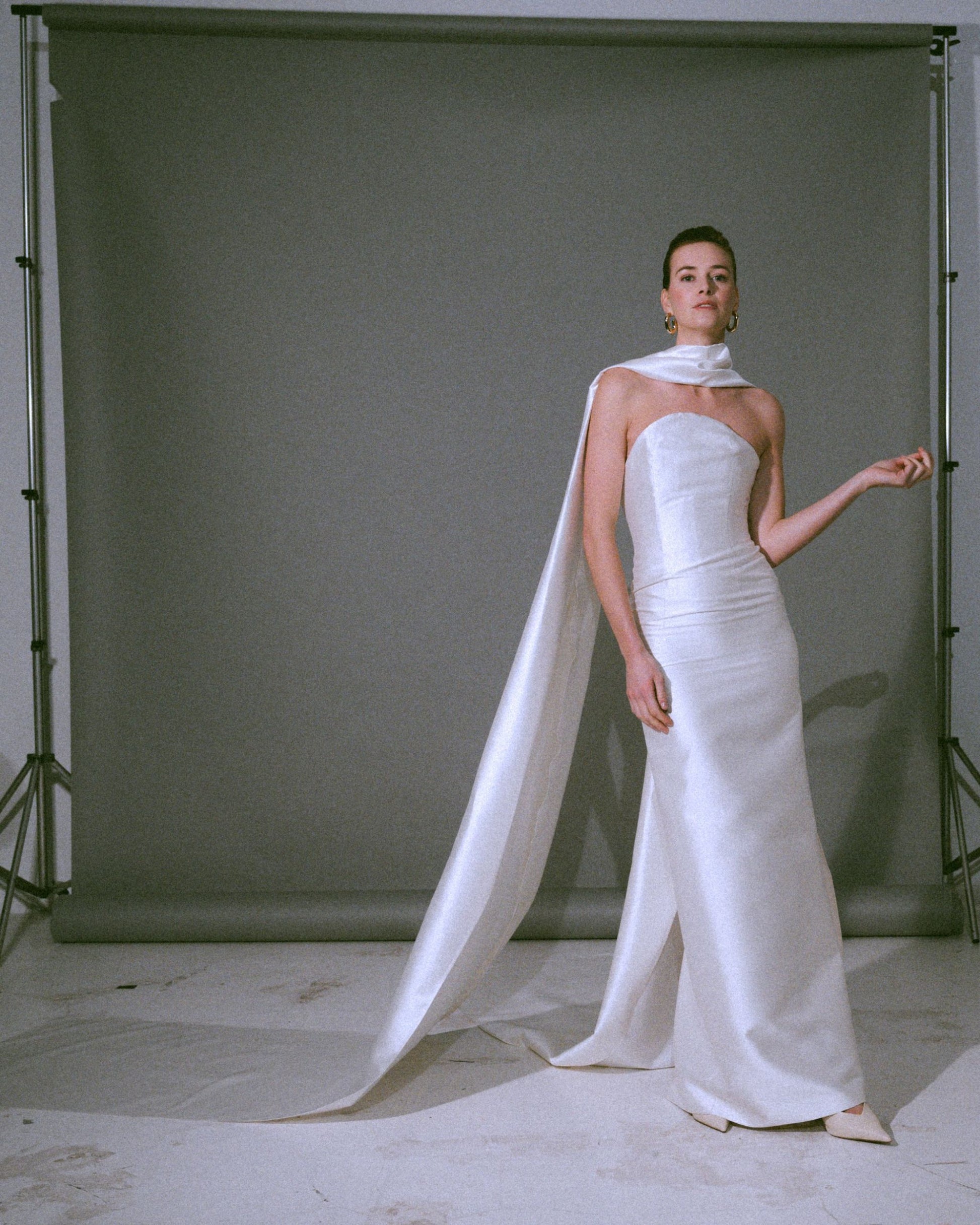Full look of the Pia wedding gown, a handmade silk bustier wedding dress with a dramatic scarf cascading to the floor, available at Georgette bridal boutique in Brussels and online at georgettebridal.com.