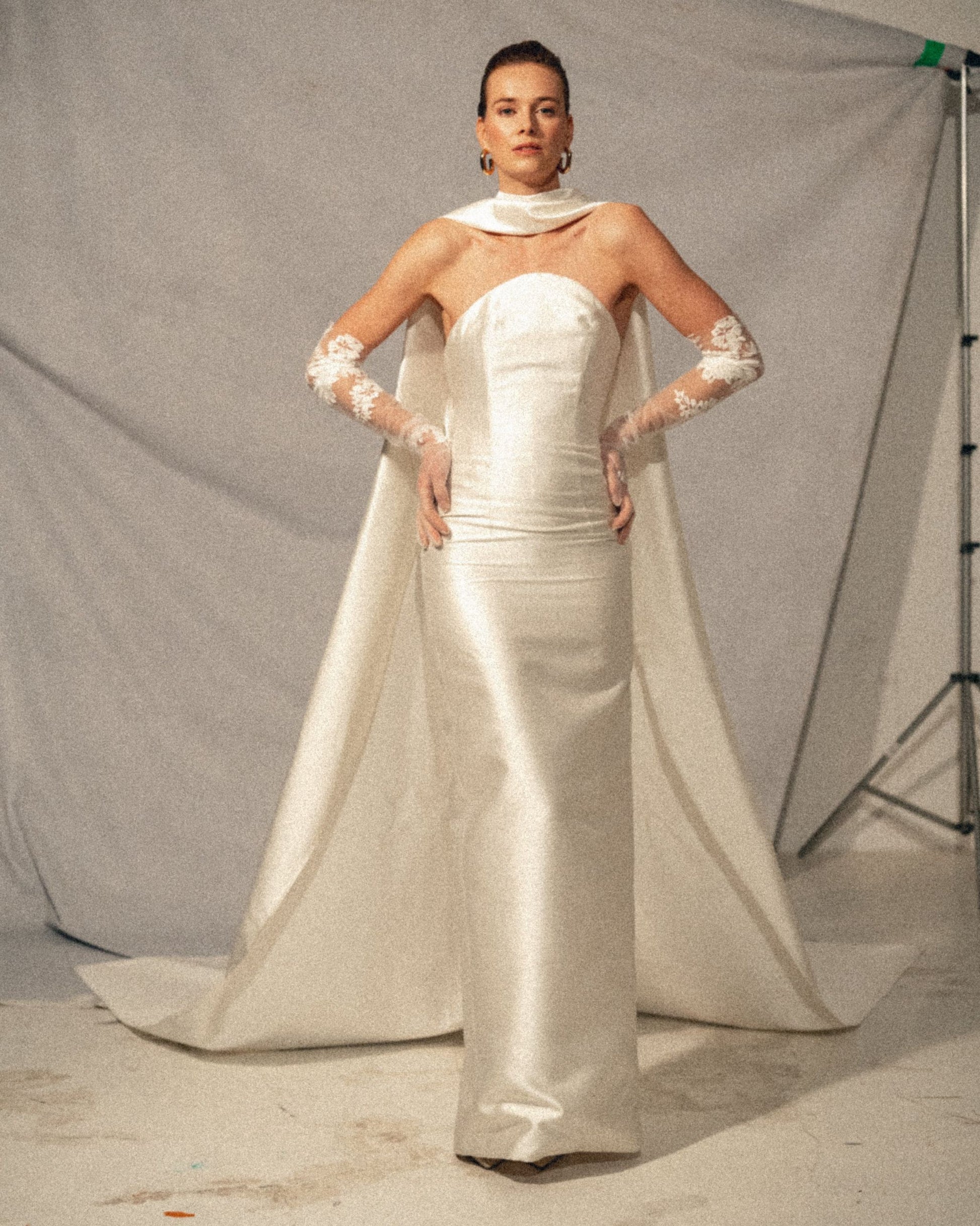 Front view of the Pia wedding gown, a handmade silk bustier wedding dress with a dramatic scarf cascading to the floor, available at Georgette bridal boutique in Brussels and online at georgettebridal.com.