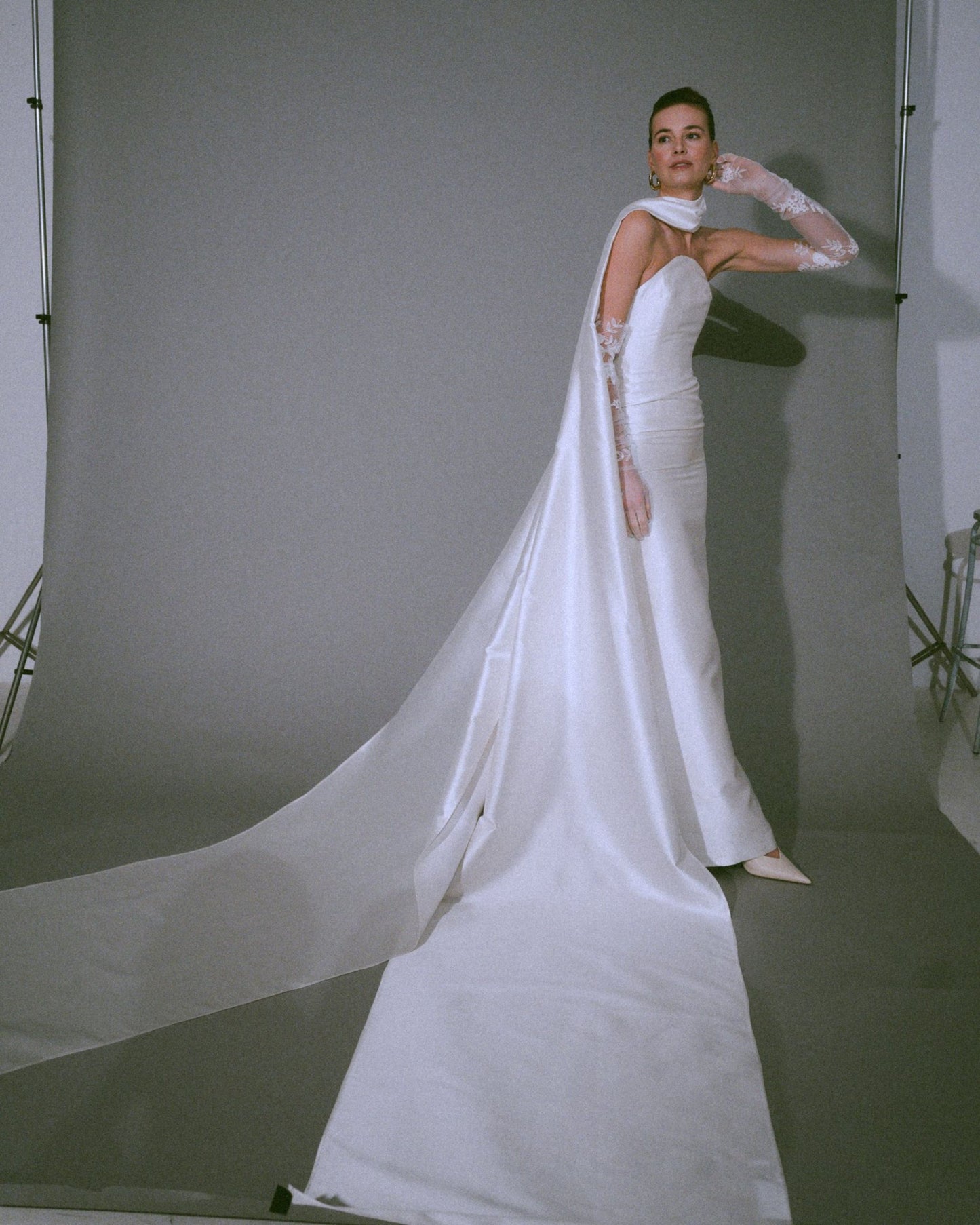 Full look of the Pia wedding gown, a handmade silk bustier wedding dress with a dramatic scarf cascading to the floor, available at Georgette bridal boutique in Brussels and online at georgettebridal.com.
