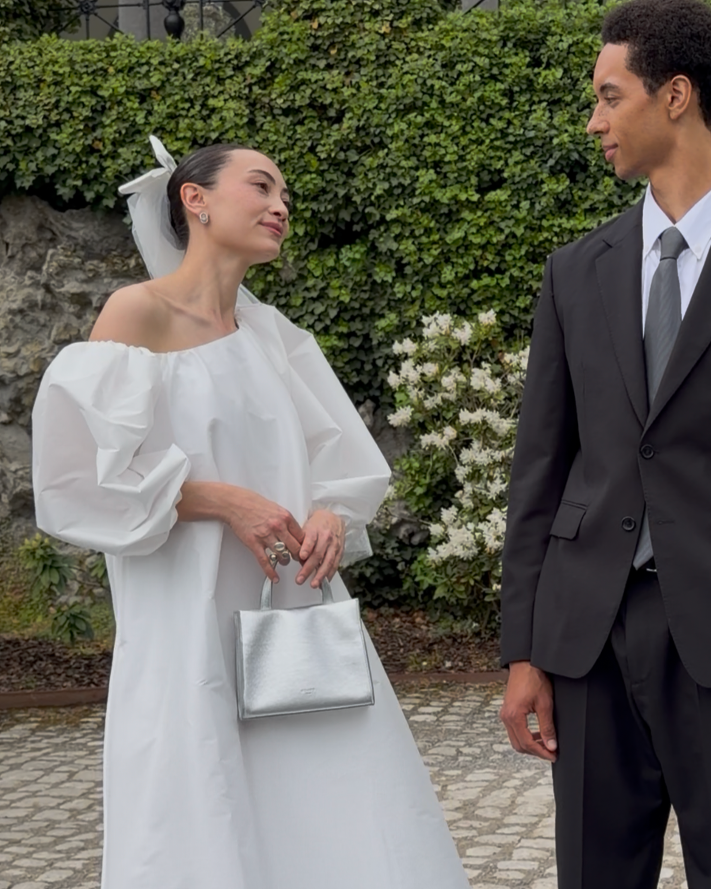 Silver mini bag styled with modern bridal outfit, available at Georgette bridal boutique in Brussels and online at georgettebridal.com