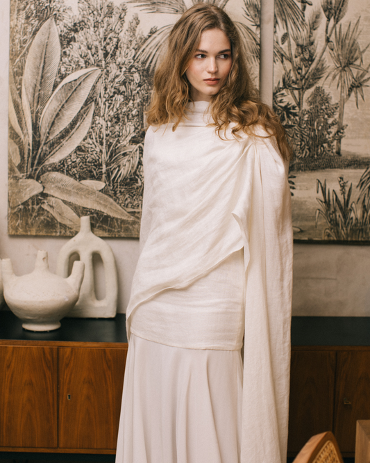 Model posing with the linen Sintra Bridal Cape by The Muse Collective available at Georgette Brussels