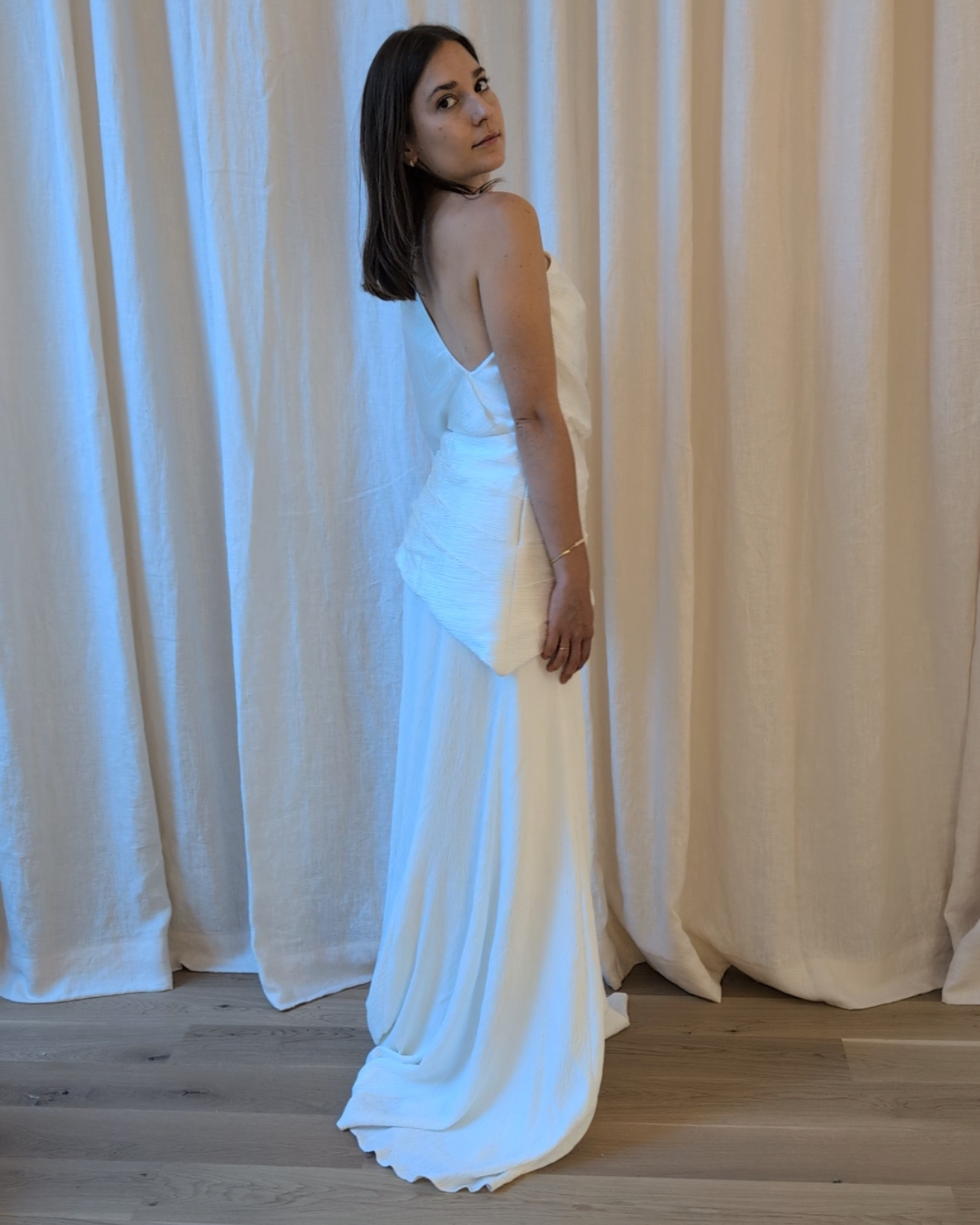 Woman trying on the Lucia Set by The Muse Collective available at Georgette Studio in Brussels